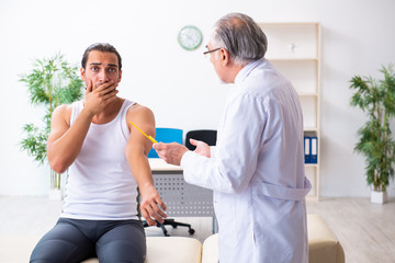 Young male patient visiting experienced doctor