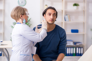 Fototapeta premium Young patient visiting doctor in hospital
