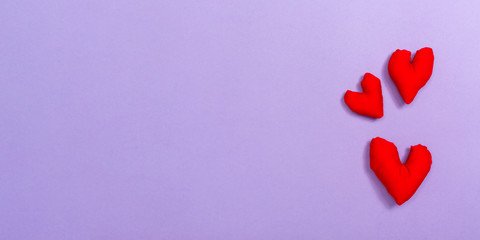 Heart cushions in Valentine's day theme on a purple paper background