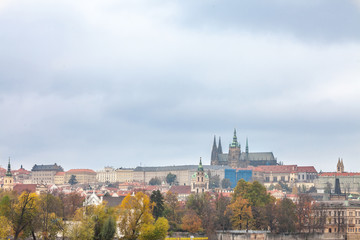 Fototapeta na wymiar Panorama of the Old Town of Prague, Czech Republic, in autumn, at fall, with Hradcany hill and the Prague Castle with the St Vitus Cathedral (Prazsky hill) seen from Vltava river.