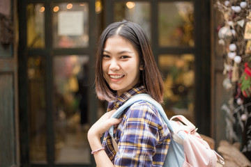 Smiling freedom tourist women backpack travel in old town city street of Bangkok