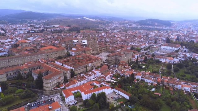 Saint James of Compostella - Santiago de Compostela, Galicia, Spain. Aerial cityscape, drone approaching cathedral, wide angle shot
