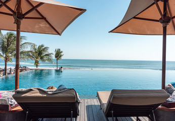 pool and deck chairs at a beach resort in bali