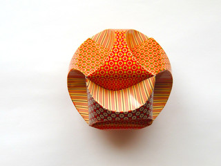 Cardboard ball with a pattern on a colored background. Macro. Brightly. Colorfully.
