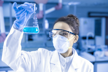 Female scientist looking at the scientific sample in the CDC laboratory.