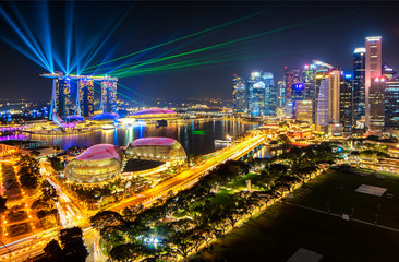 Fototapeta na wymiar Colourful Laser Light showing at Marina Bay with Skyscraper Buildings of Singapore Background, Singapore