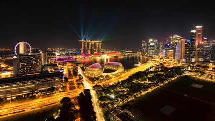 Fototapeta na wymiar Illumination of Skyscraper Buildings and Laser Show at Marina Bay, Singapore