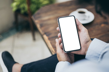 Mockup image blank white screen cell phone.man hand holding texting using mobile on desk at office.background empty space for advertise text.people contact marketing business,technology 