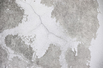 White and Grey old dirty wall with surface peeling shabby cracked damaged  plaster mortar  Cement  textured  background close up