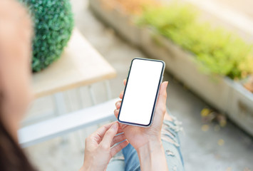 Mockup image blank white screen cell phone.woman hand holding texting using mobile.background empty space for advertise text.people contact marketing business,technology 