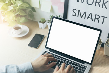 mockup image blank screen computer with white background for advertising text,hand woman using laptop contact business search information on desk at office.marketing and creative design