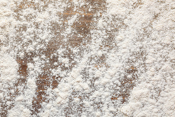 Scattered flour on wooden background