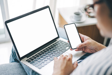 mockup image blank screen computer,cell phone with white background for advertising text,hand woman using laptop texting mobile contact business search information on desk in office.marketing,design