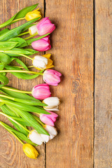 Beautiful tulip flowers on wooden background