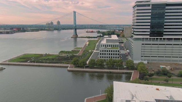 Aerial flying over the waterfront of Camden & Ben Franklin Bridge. New Jersey, USA