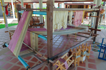 Weave silk cotton on the manual wood loom in Thailand