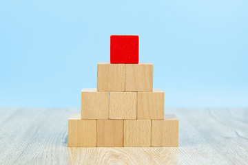 Wooden block toy stacked in pyramid shape without graphics for Business design concept and activity for child foundation practice skills.