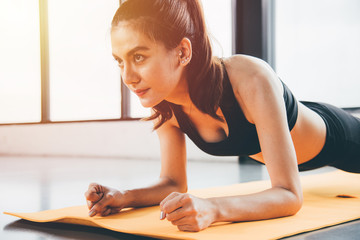 Beautiful woman exercise workout with planking on mat