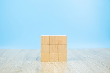 Wooden block toy stacked in square shape without graphics for Business design concept and activity for child foundation practice skills.