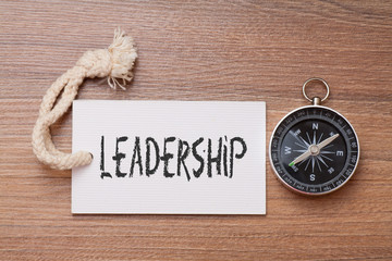 Leadership word - business tips handwriting on label with compass