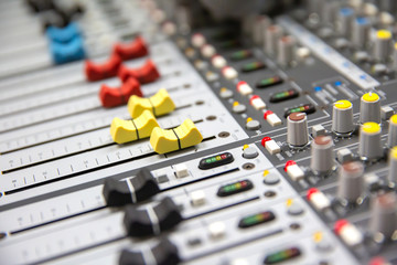 Close up Volume adjustment slides on sound audio mixer and av equipment in Studio room for...