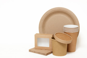 Eco kraft paper tableware. Paper cups, dishes, fast food containers, paper napkins isolated on white background. Recycling concept. Zero waste.