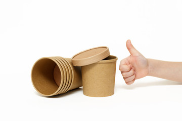 Eco kraft paper tableware. Fast food paper containers and children's hand isolated on white background. Recycling concept. Zero waste.