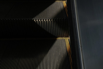 Escalators line abstract pattern against light background.
