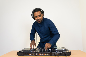 Male DJ playing music on white background