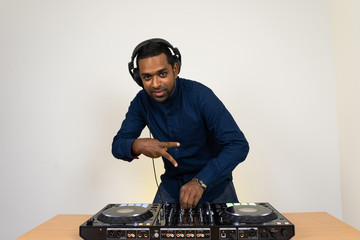 Male DJ playing music on white background