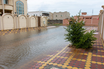A stormy day in the United Arab Emirates leaves flooding throughout residential areas of the city of Ras al Khaimah and surrounding Emirates. No school. Flooded Street. Weather concept.