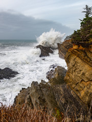 Big waves crashing on the cliffs of the Pacific Ocean shore,  at Shore Acres State Park, Charleston Oregon, USA