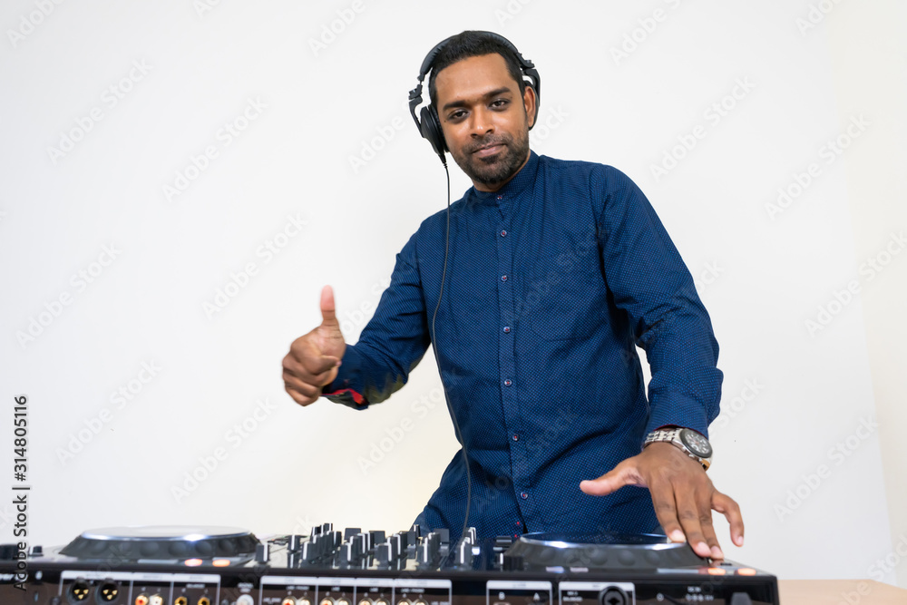 Wall mural male dj playing music on white background