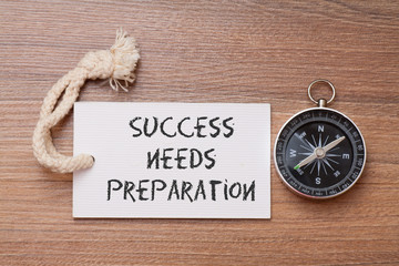 Success need preparation -  Motivation advice handwriting on label with compass