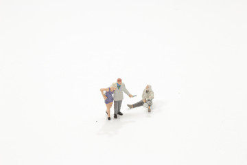 mini figure giving a coin to homeless man in need