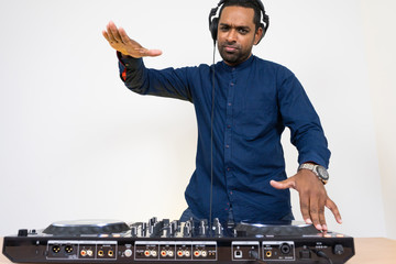Male DJ playing music on white background