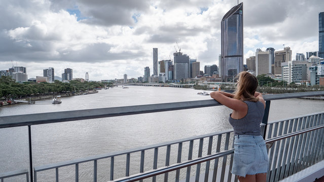 Young woman looking at the skyline of Brisbane in Australia
