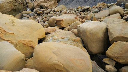 Volcanic stones on the ocean coast. smooth forms and lines in brown volcanic blocks on the Japanese islands. Aburatsu