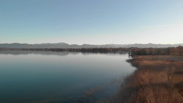A drone shot of the coast an a lake near Starnberg in Germany with calm water
