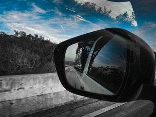 Fototapeta premium Black Mirror car while driving on a highway in Thailand