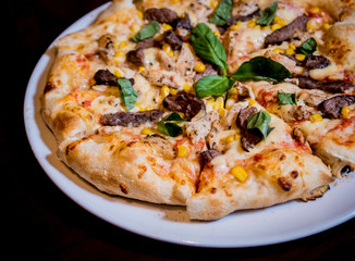 Tasty pizza with chicken and vegetables. Restaurant.