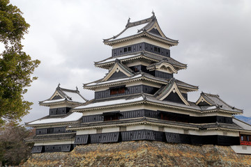 Matsumoto castle  against  cloudy sky, know as craw castle, a famous Traditional Japanese architecture in Nagano, Japan