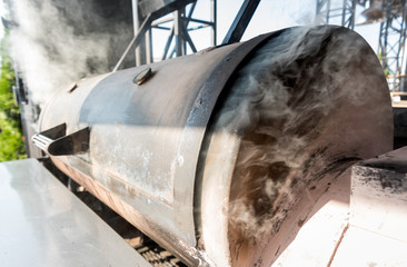 Large barbecue smoker grill at the park. Meat prepared in barbecue smoker.