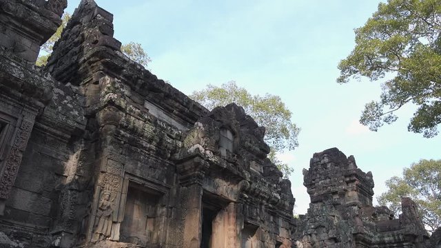 Close Exterior Pan Shot of Historical Temple Ruins With Trees in the Daytime Near Angkor Wat