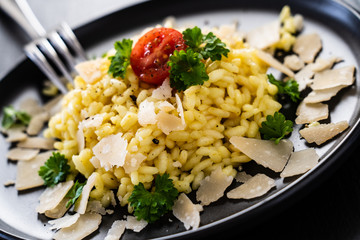 Risotto with parmesan on black stone plate