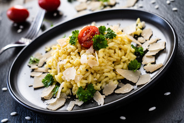Risotto with parmesan on black stone plate