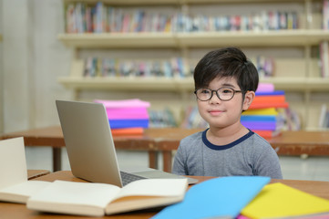 Group of Asian Student Kid Learning to use Laptop in Library with Women Teacher, Shelf of Books in Background, Asian Student Education Concept