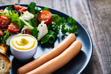 Continental breakfast - boiled sausages, toasts and greek salad