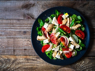 Tasty salad - vegetables , feta cheese and barbecue chicken fillet
