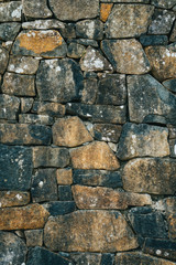 Old style stacked stone wall texture.